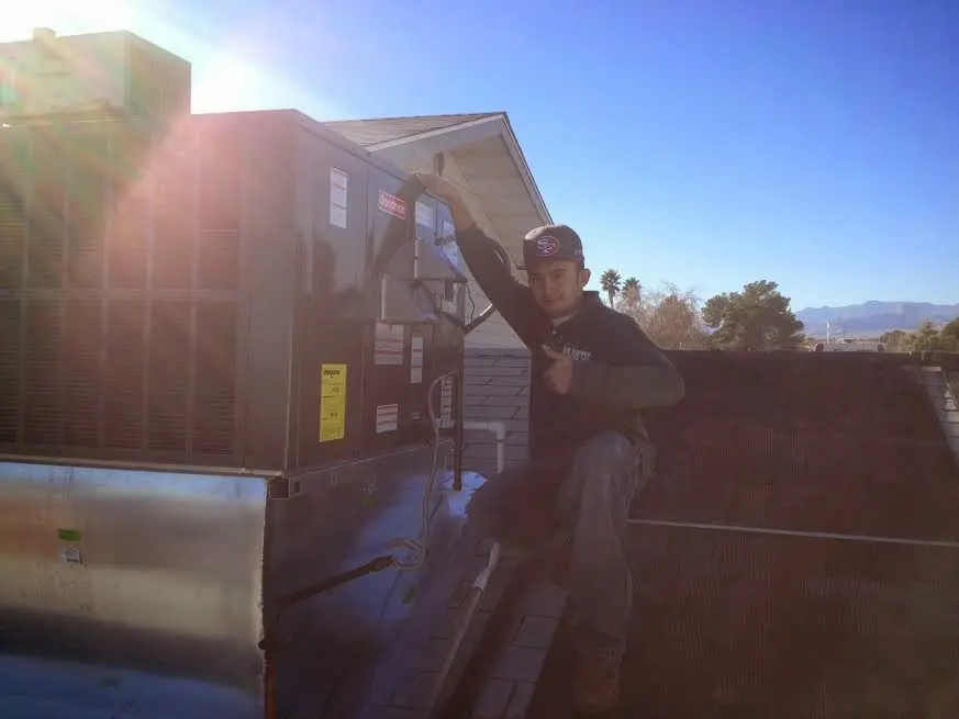 HVAC technician performing HVAC Inspection on a rooftop unit in New Carlisle